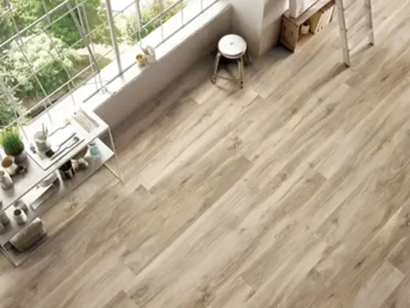 A view of a room with wooden floors and white walls.