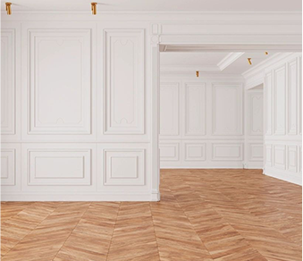 A large empty room with white walls and wooden floors.